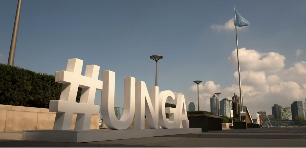 Photo: Large signage reading "#UNGA" outside the United Nations General Assembly building.